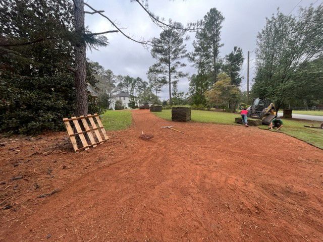 a dirt road with a wooden pallet on the side of it