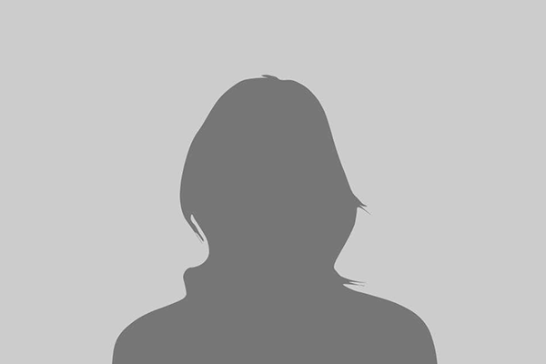 Silhouette of a person with short hair and a high collar, against a gray background.