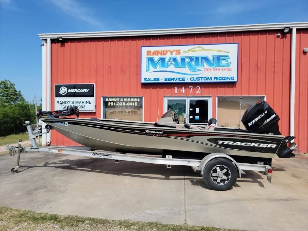 A Tracker boat on a trailer in front of Randy's Marine, a red building with a blue sign.