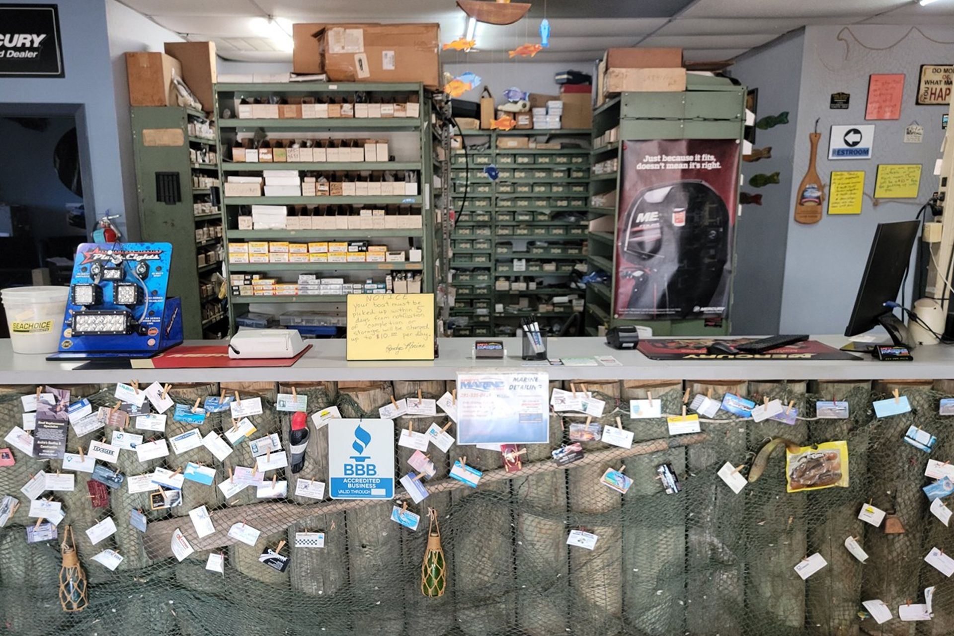 Inside of a marine supply store; a counter with items is visible. Shelves hold inventory in the background.