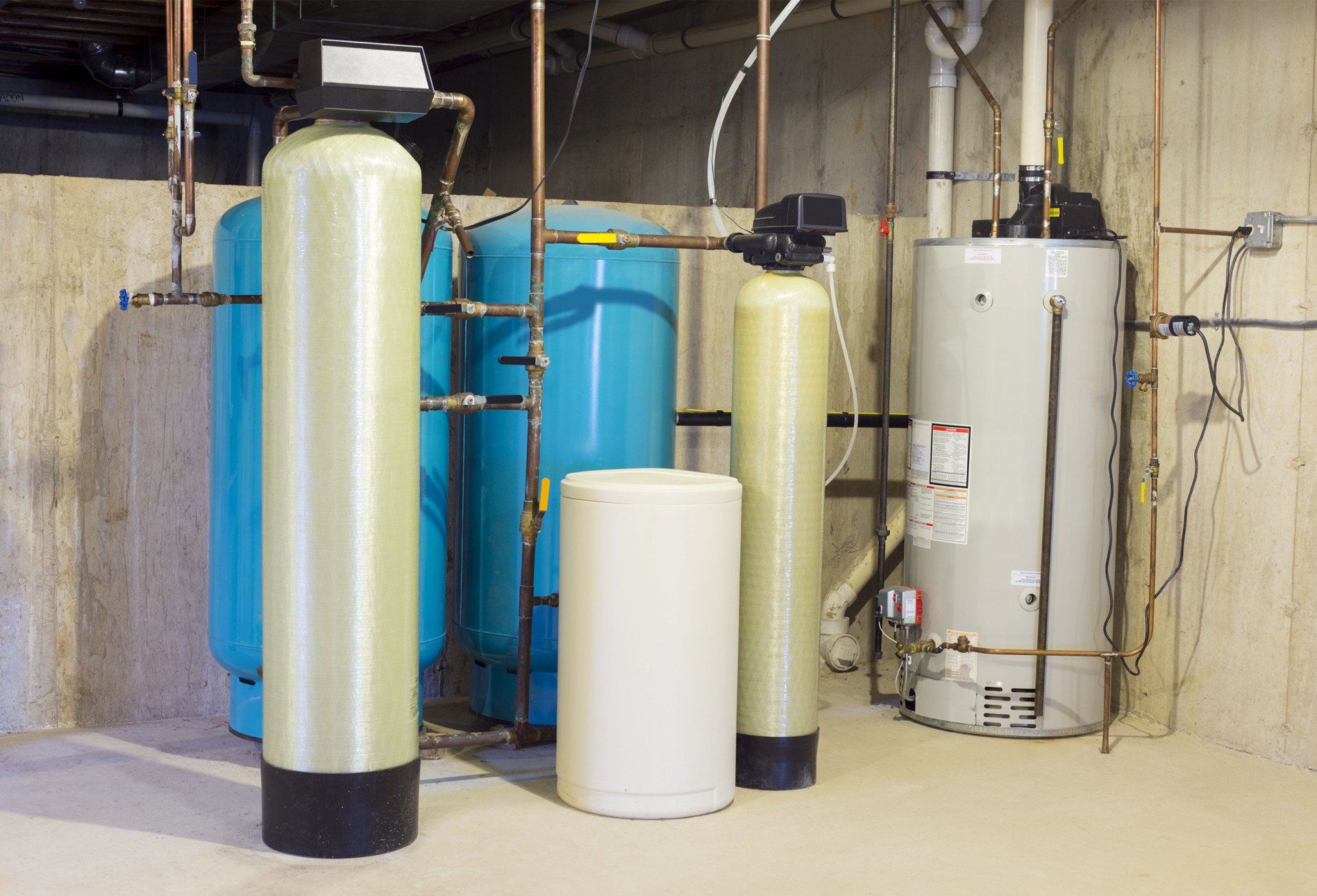 A room filled with water tanks and a water heater.