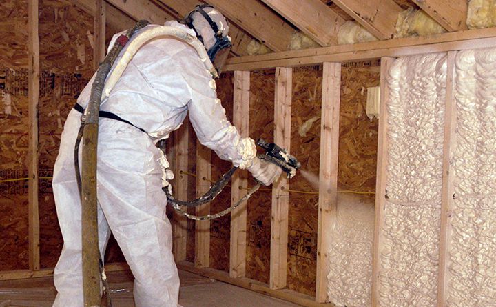 A man spraying foam insulation