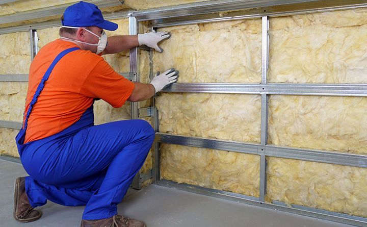 A man installing insulation