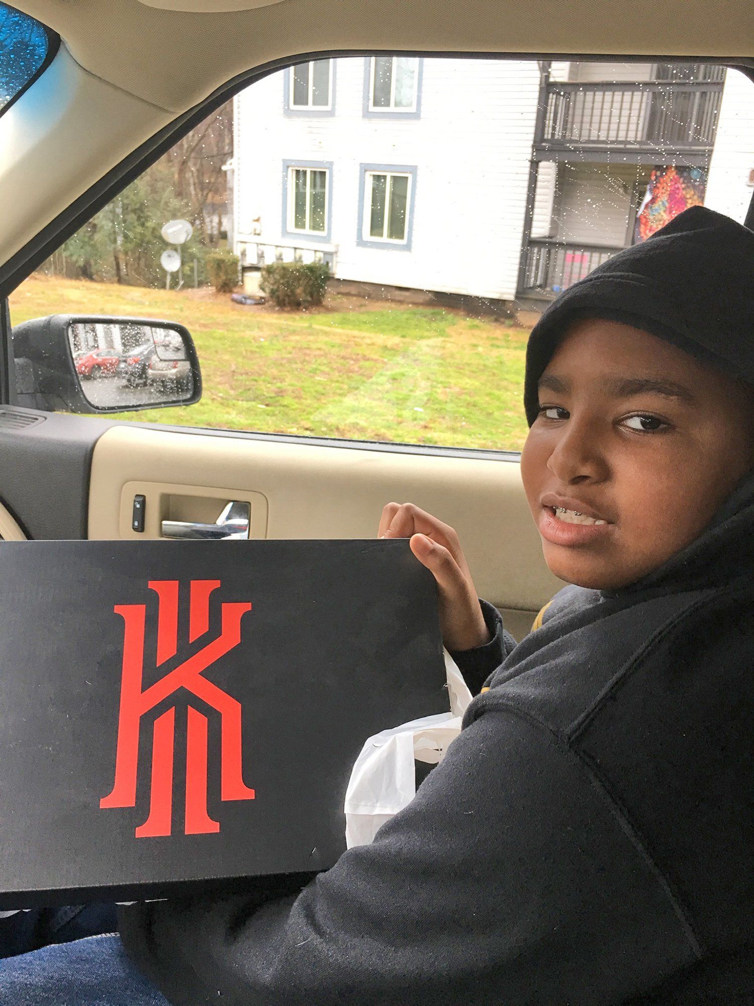 Kid showing a shoe box