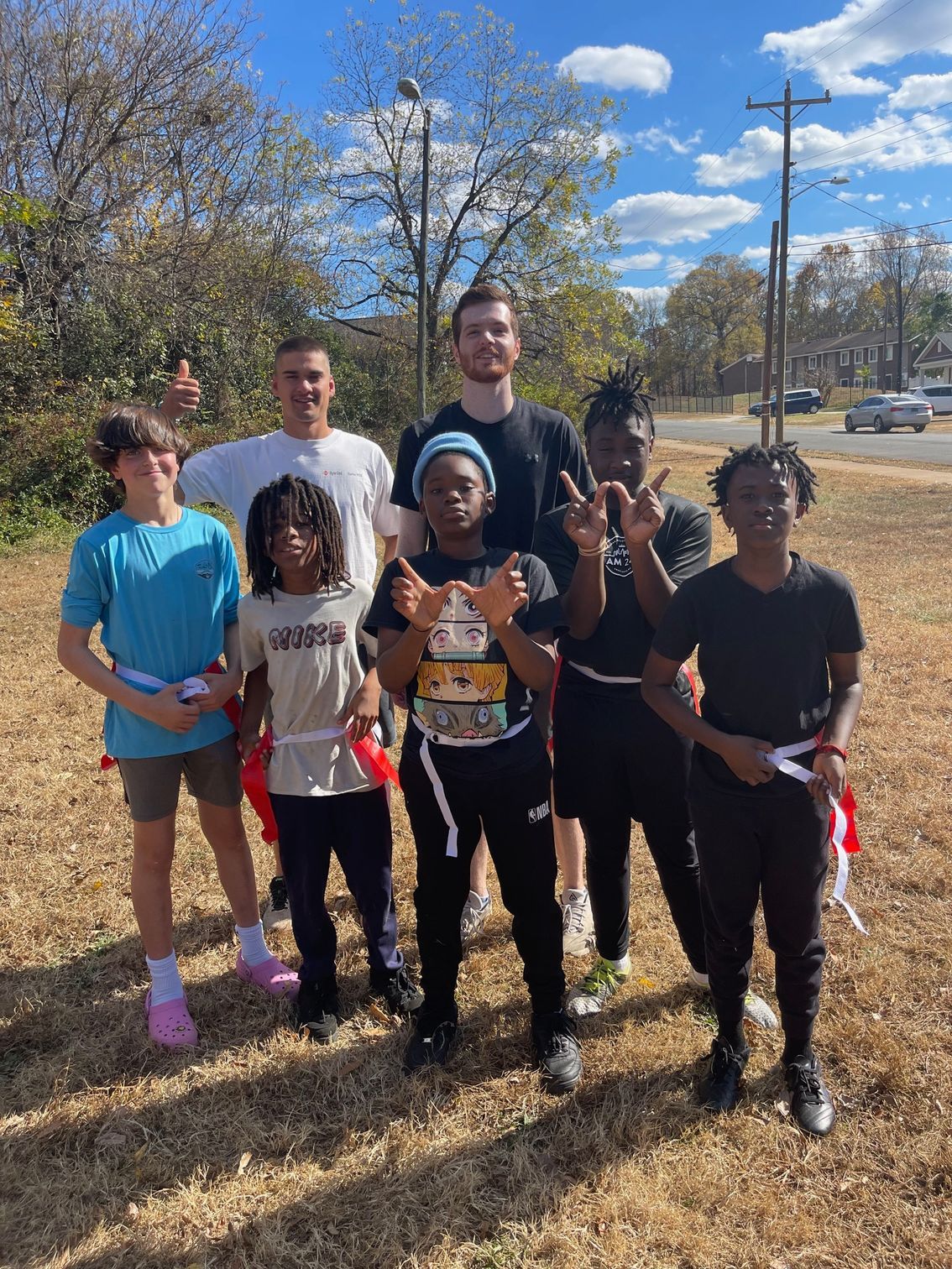 An outdoor group photo of seven boys