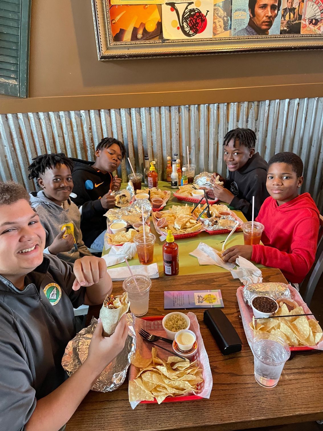 Five boys eating in a restaurant