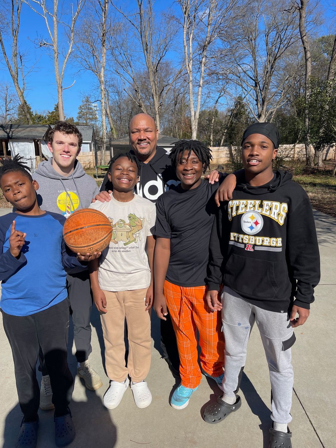 Group photo with one boy holding a basketball
