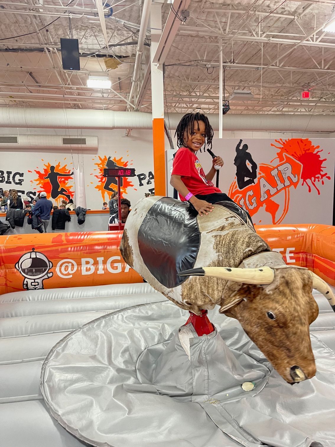 Young boy in red shirt is posing for a photo