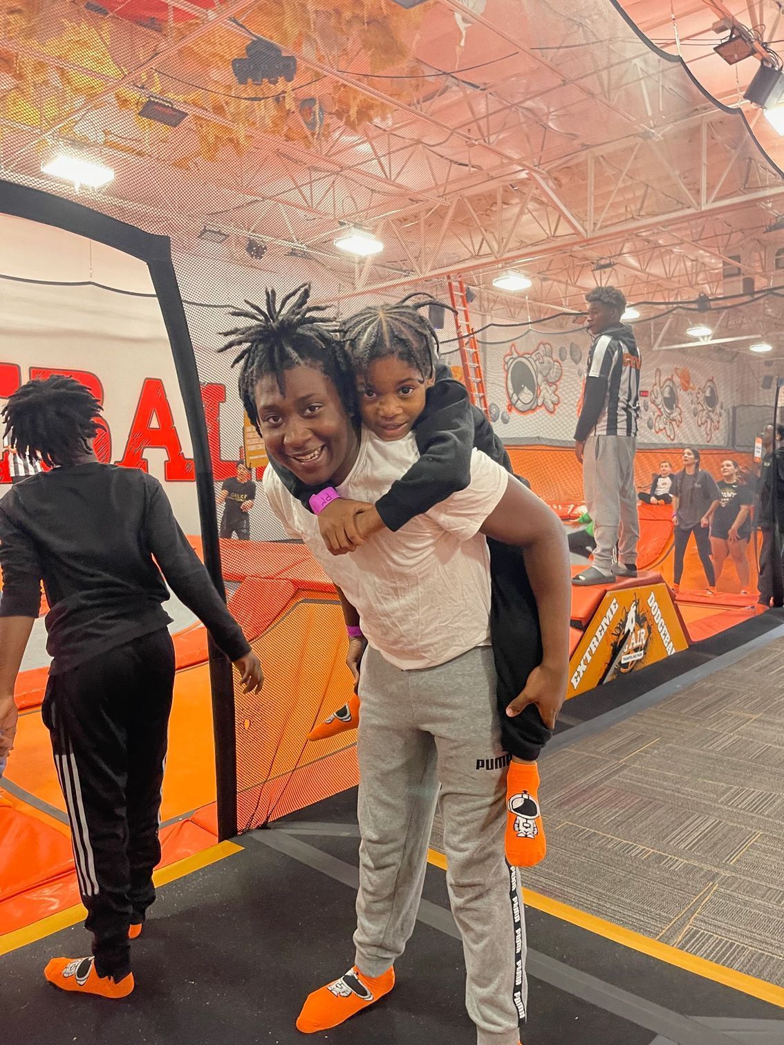 A man is carrying a young boy on his back