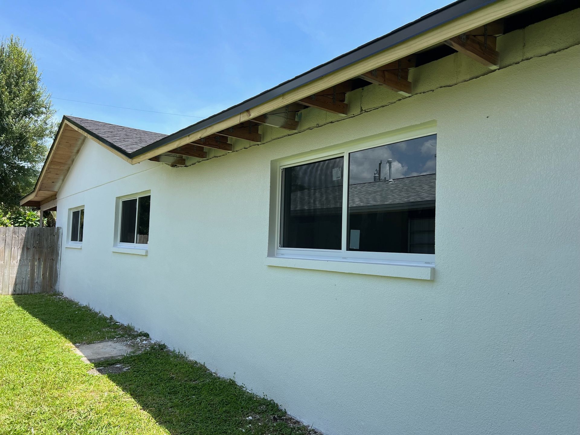 A white house with a lot of windows on the side of it