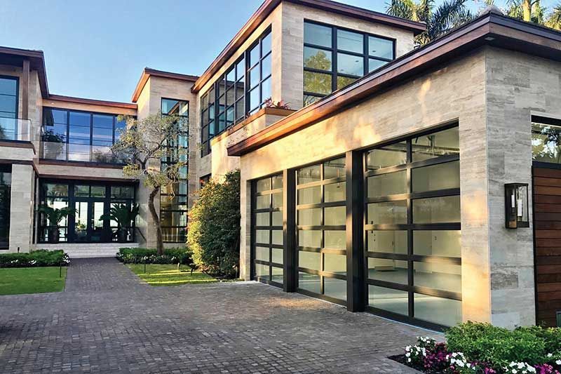 A large house with a lot of windows and a garage.