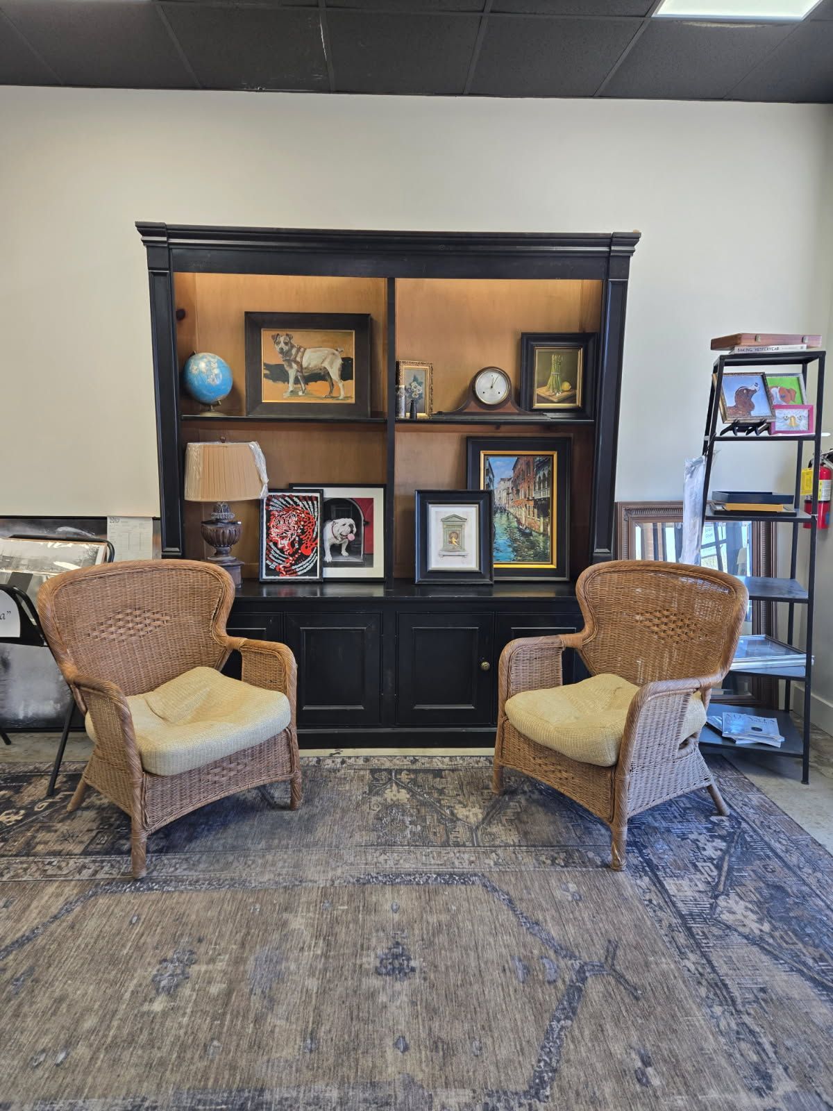 Two wicker chairs are sitting in front of a bookshelf in a living room