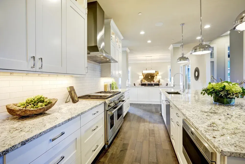 Kitchen with black granite counter tops and stainless steel appliances.