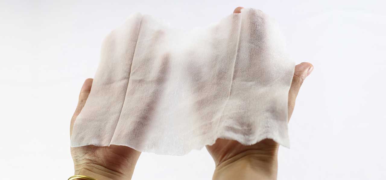 Hands wearing white gloves raised against a white background