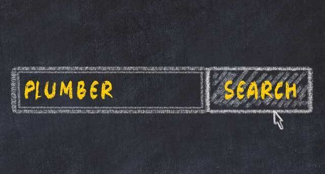 Chalkboard-style search bar labeled “PLUMBER” with a “SEARCH” button and cursor on a dark background