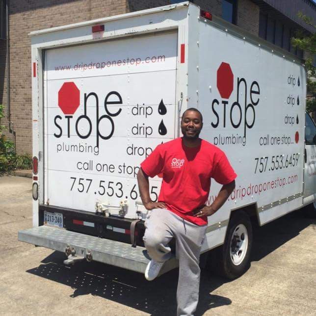 Plumber leaning on a white service van with &ldquo;one stop plumbing&rdquo; branding on the side.