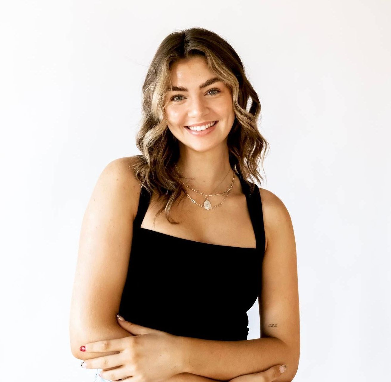 Kayden Collette in black top against a white backdrop.