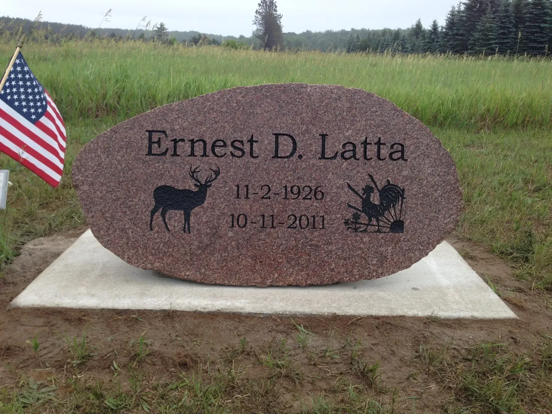 A reddish-brown tombstone with name 