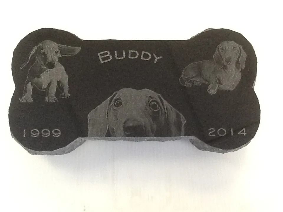 Black bone-shaped pet memorial with engraved dog photos and 