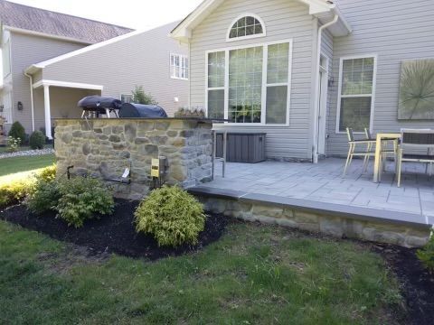 Stone patio with grill and table