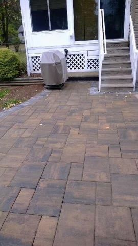 A cozy patio with brick flooring and steps