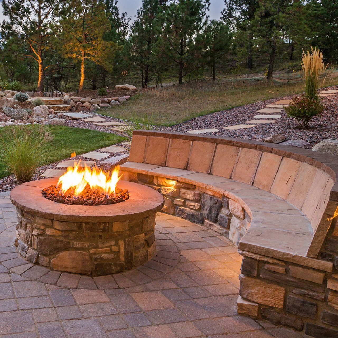 Outdoor fire pit and seat with stone veneer facing.
