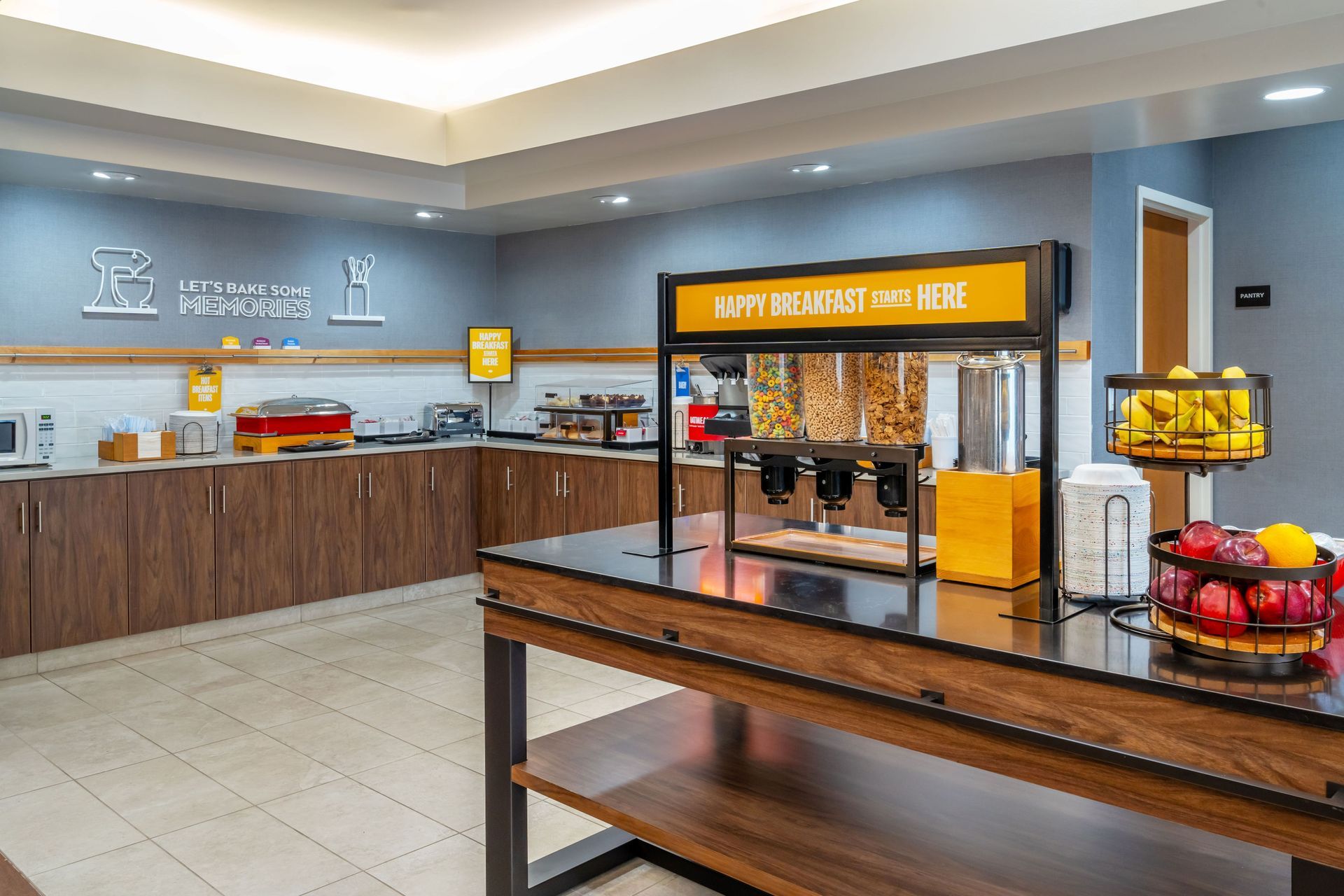 There is a table with fruit on it in the kitchen of a hotel.