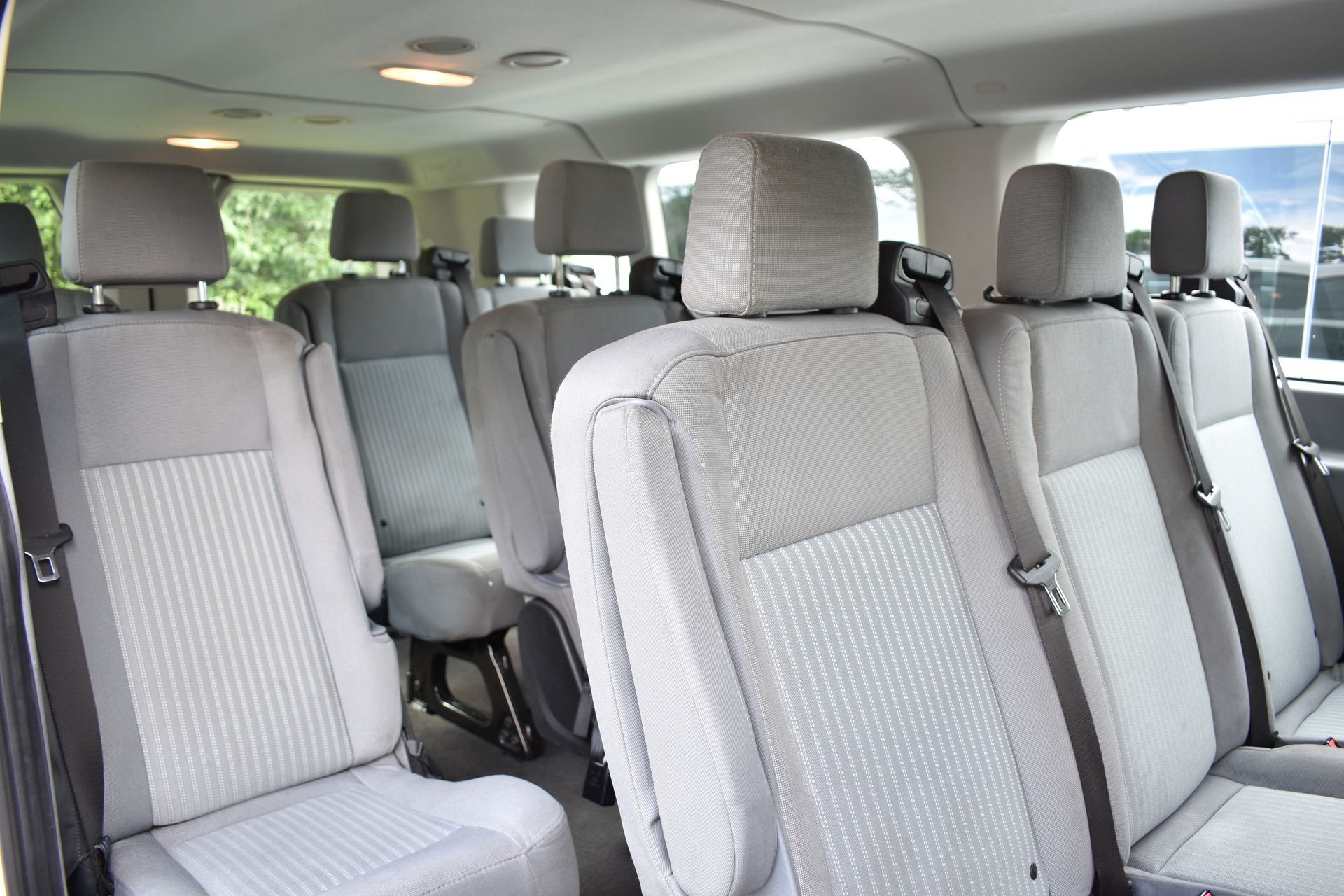 The inside of a van with a lot of seats and a window.