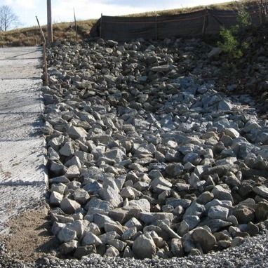 A pile of rocks on the side of a road