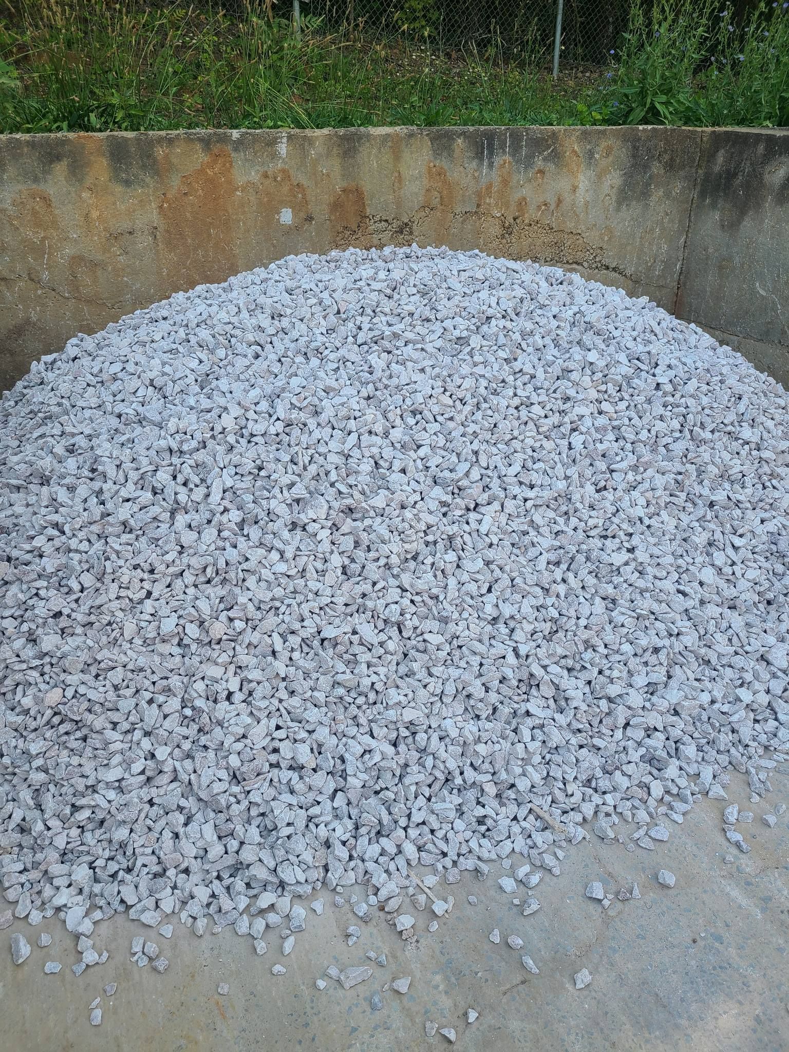 A pile of gravel is sitting on top of a concrete surface.