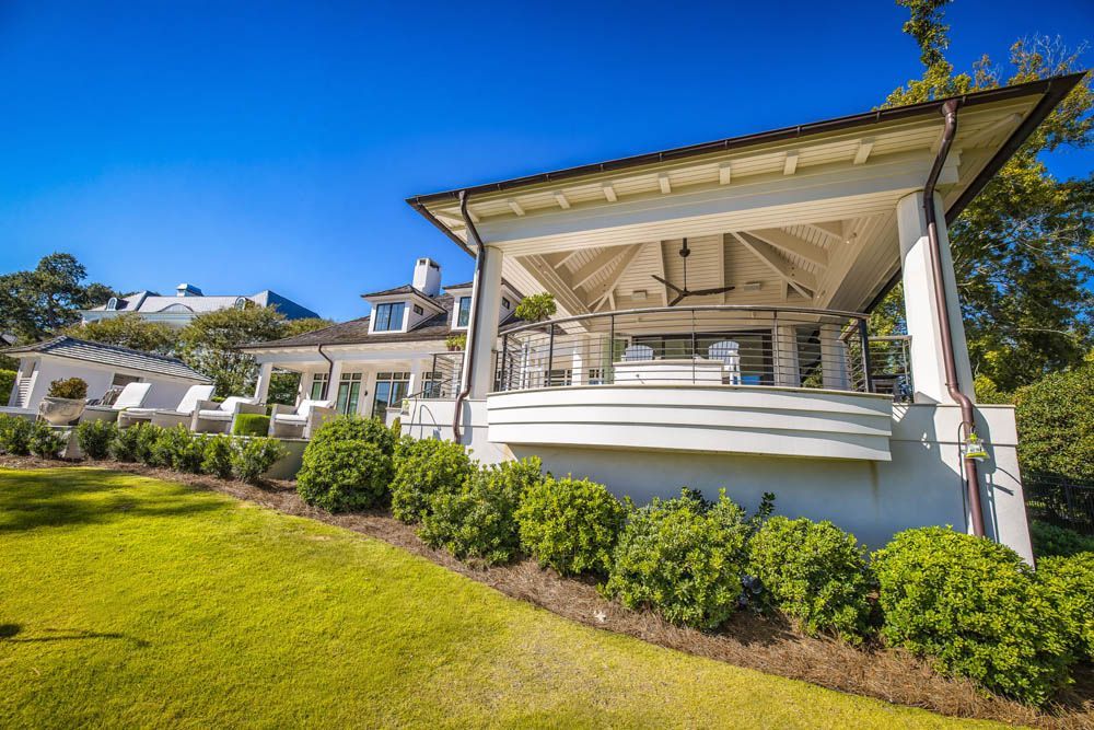 A large white house with a gazebo in the backyard.