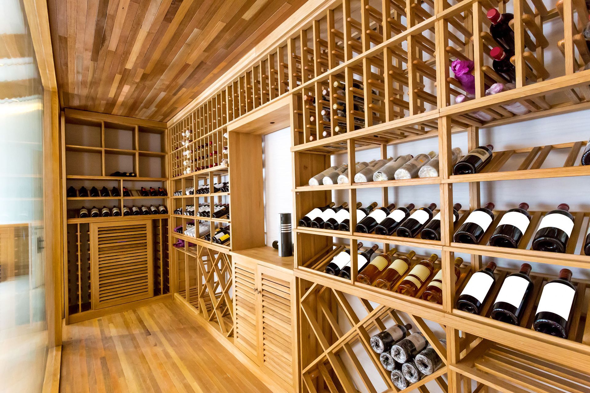 A wine cellar filled with lots of bottles of wine.
