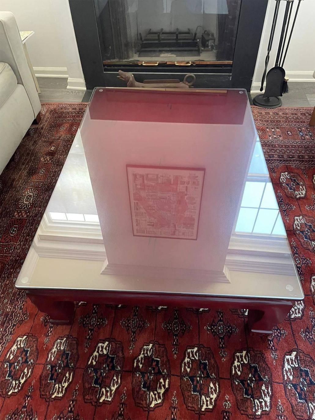 A coffee table is sitting in front of a fireplace in a living room.
