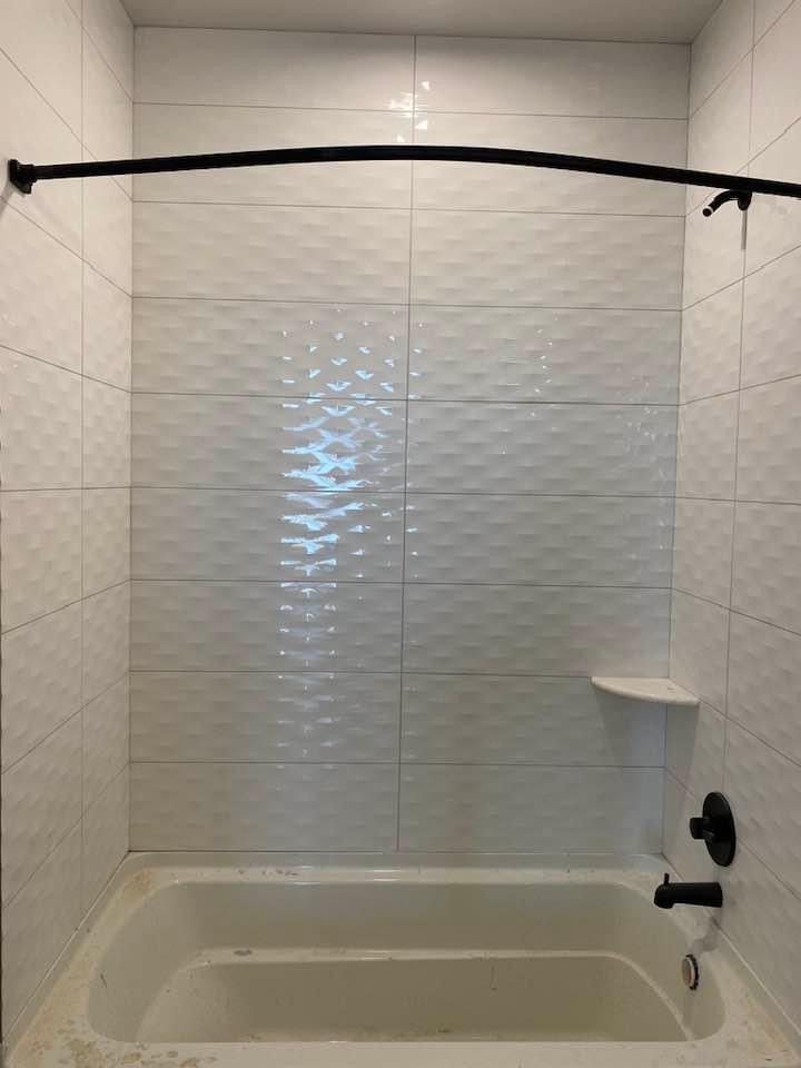 A shower with ceramic wall