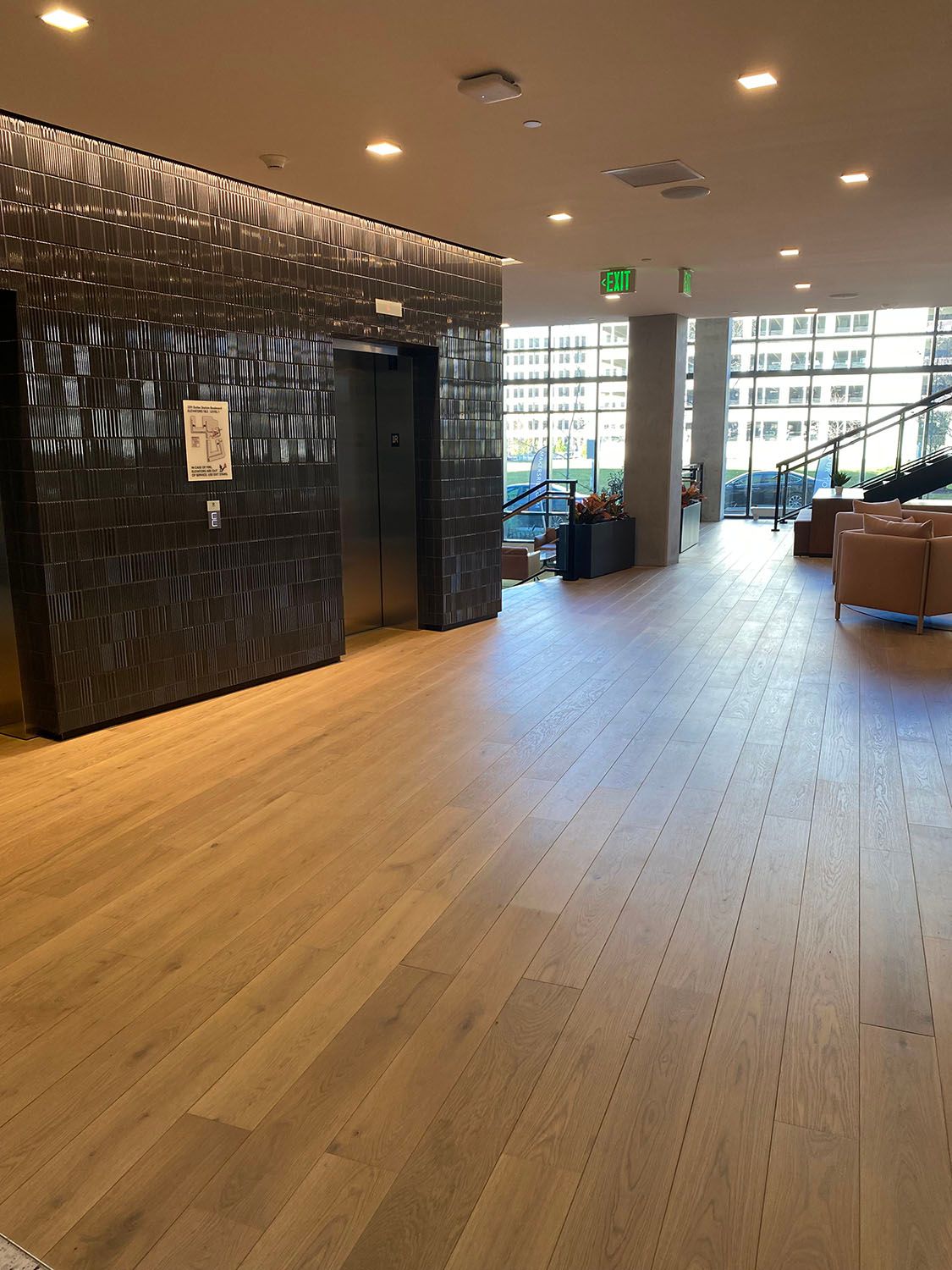 a large room with a wooden floor and a staircase