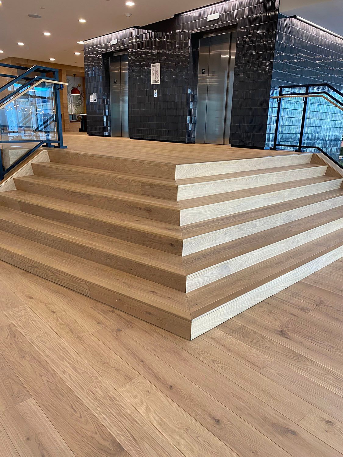 a set of stairs leading up to an elevator in a building