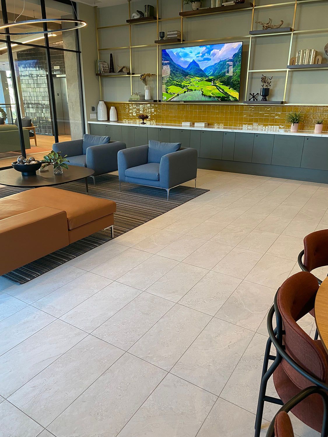 an employee lounge filled with furniture and a flat screen tv