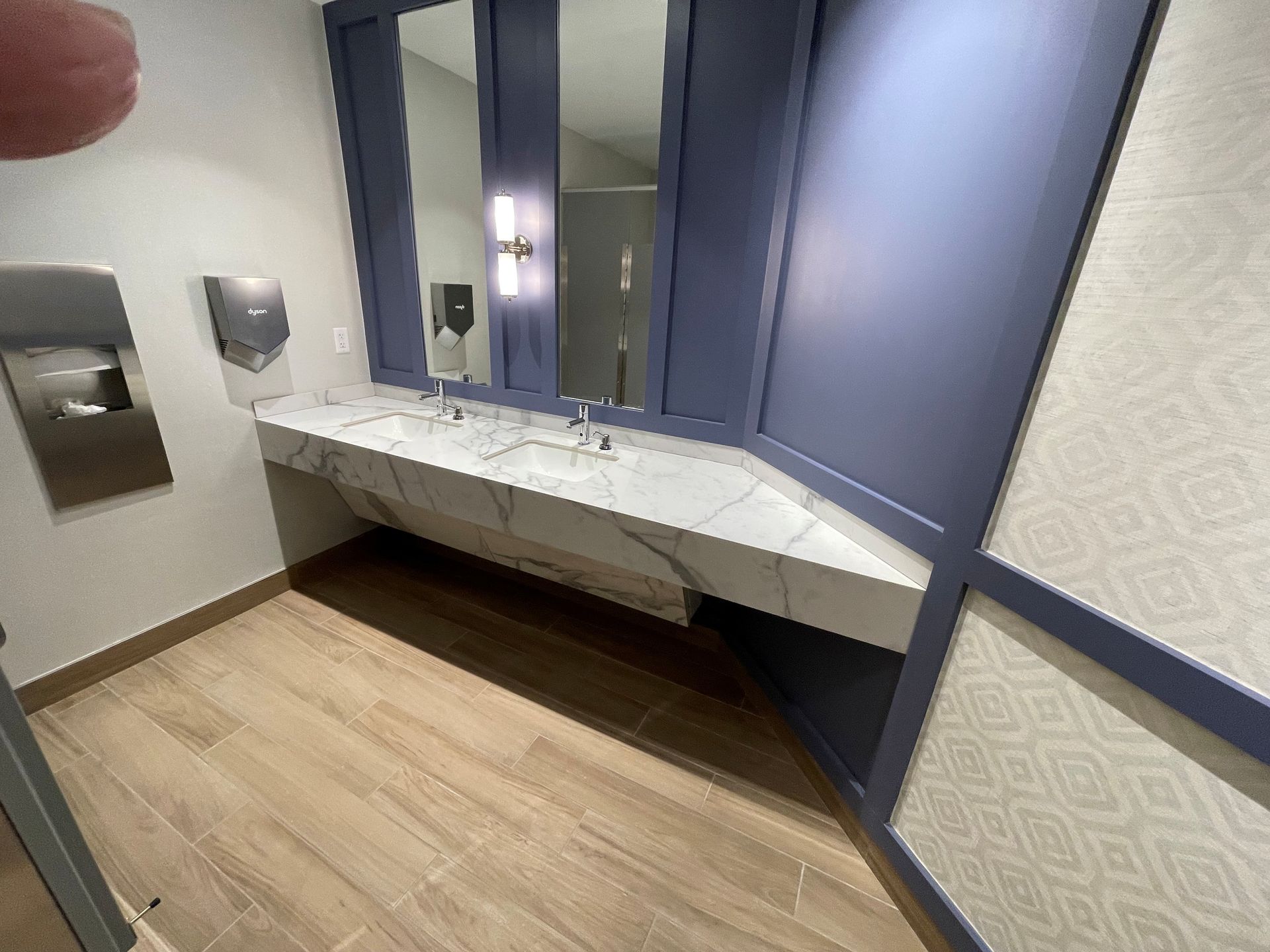 A bathroom with two sinks and a mirror