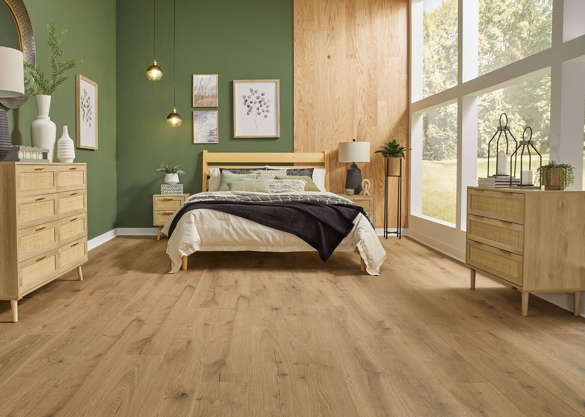 a bedroom with a bed , dresser , nightstand , and large windows .
