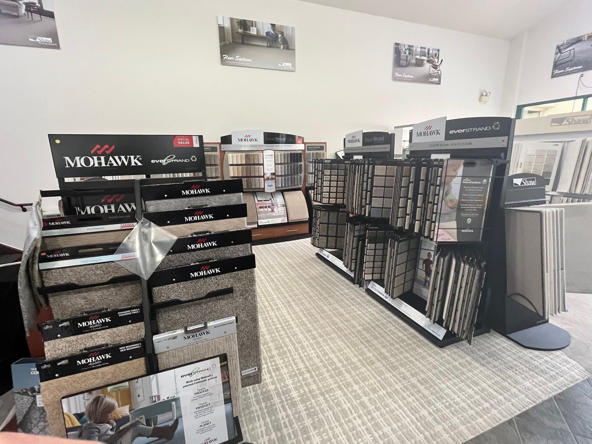 a store filled with lots of carpets and tiles .