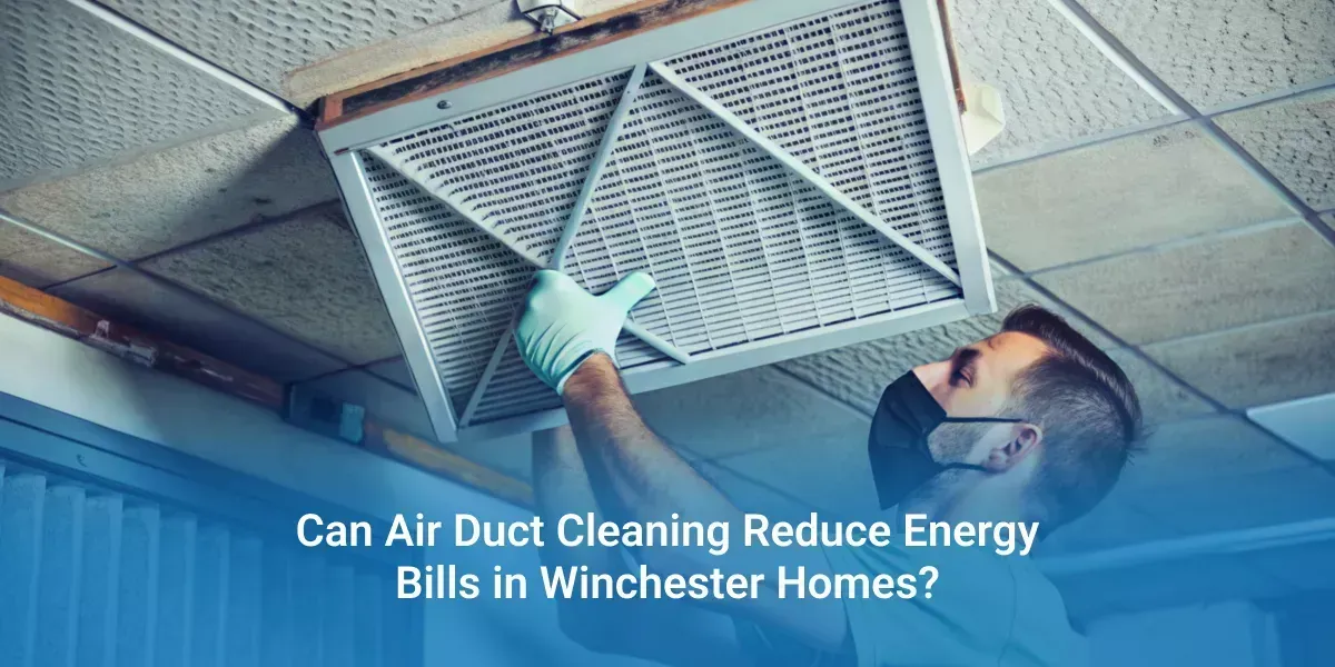 Technician cleaning a ceiling air duct beside the text “Can Air Duct Cleaning Reduce Energy Bills in Winter? Here’s How.”