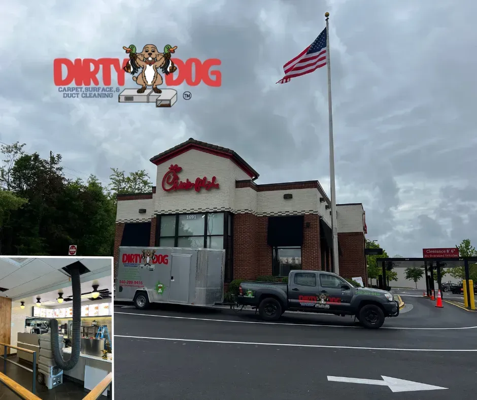 Dirty Dog car wash storefront with a U.S. flag, black pickup truck, and cloudy sky.
