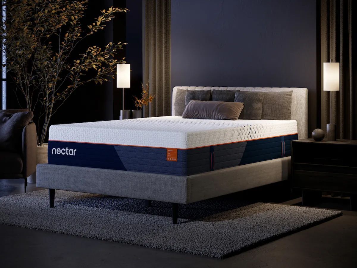 A bed with a Nectar mattress in a bedroom setting, with side tables and lamps.