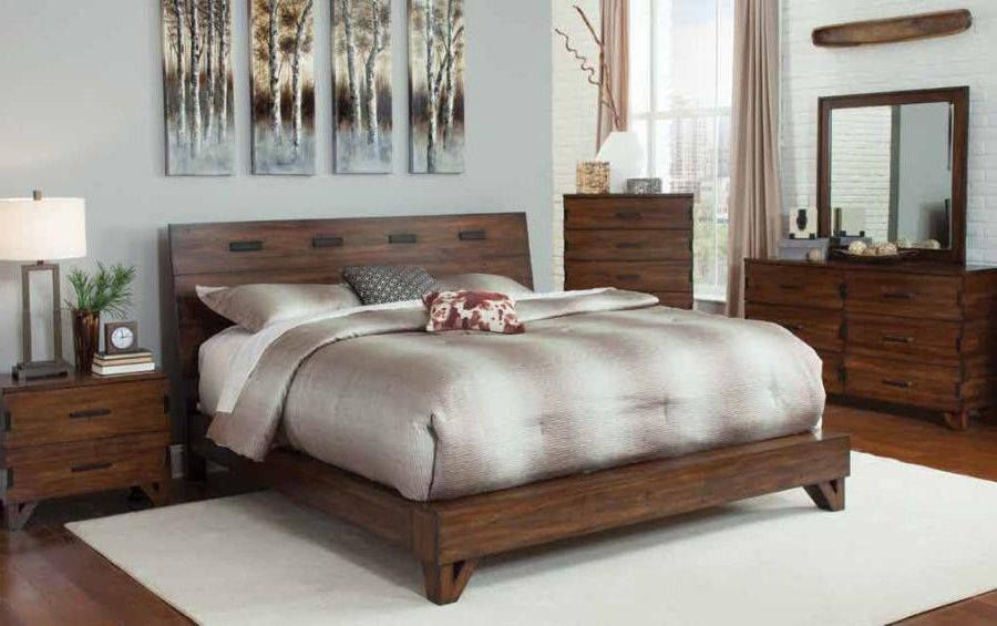 Bedroom set with a bed, nightstand, chest of drawers, dresser, and mirror; brown wood furniture.