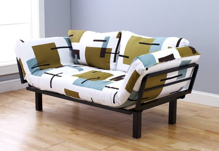 Modern futon sofa with patterned cushions and black metal frame on a wooden floor.