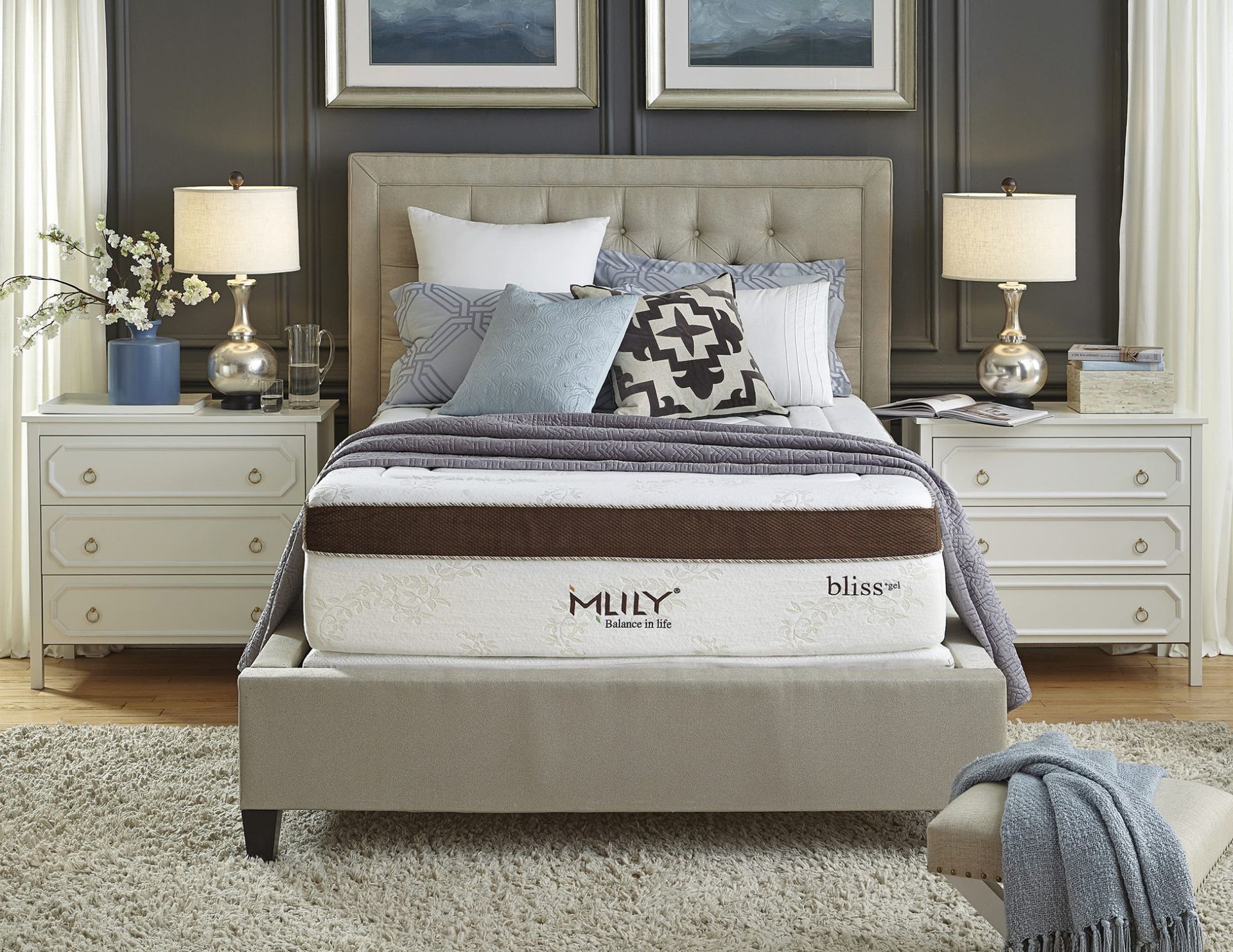 Bedroom with upholstered bed frame, mattress, nightstands, lamps, and decorative pillows.