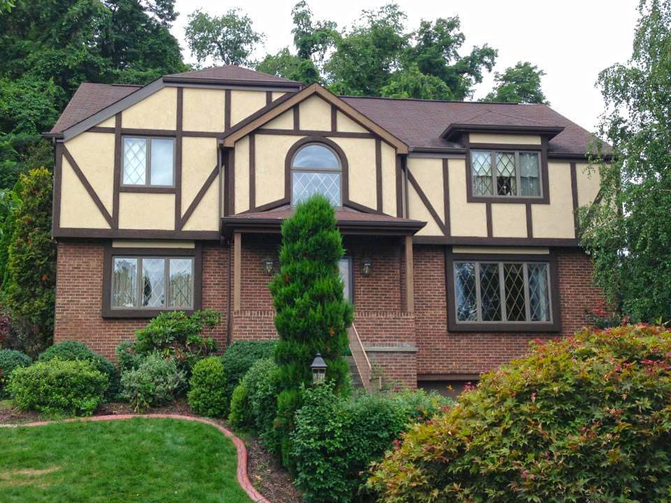 A large brick house with a brown roof