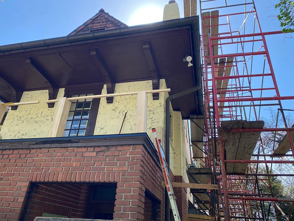 A brick building under construction with scaffolding around it.