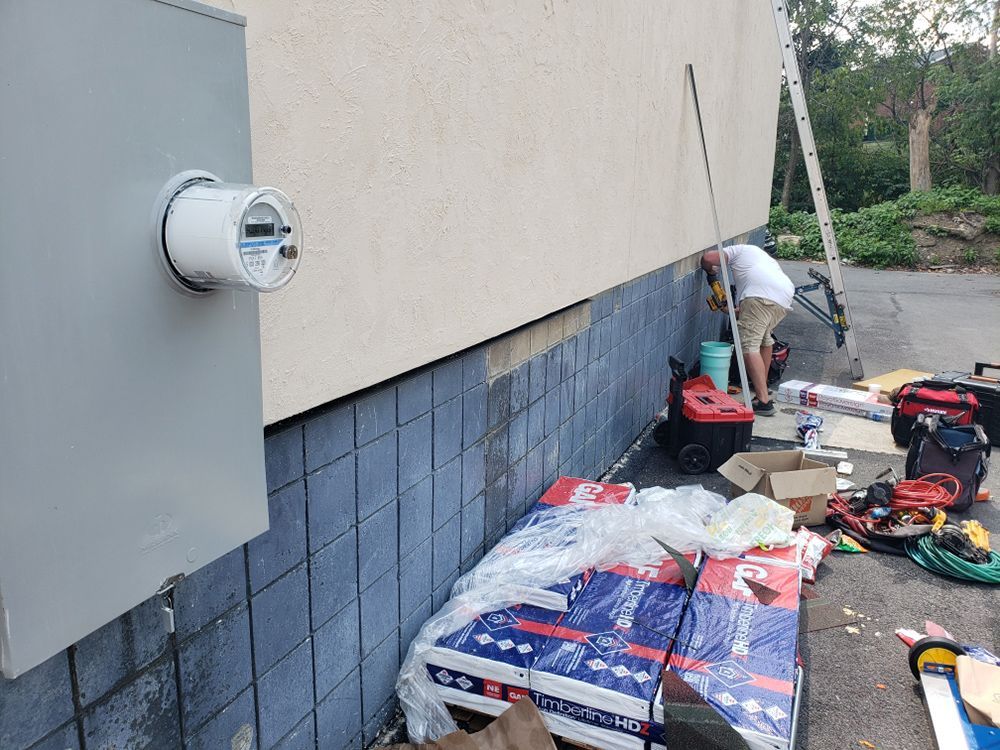 A man is working on the side of a building.