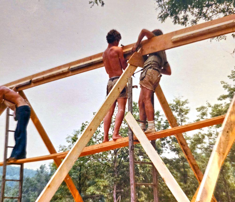 A group of men are working on a wooden structure